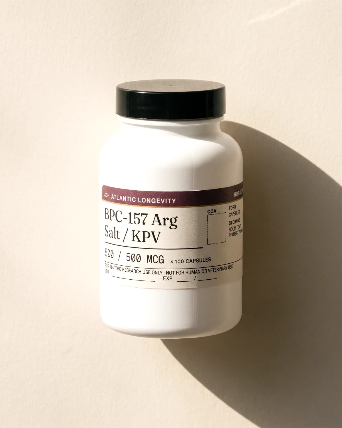 BPC-157 Arg Salt / KPV capsule bottle with Atlantic Longevity label, on bone paper