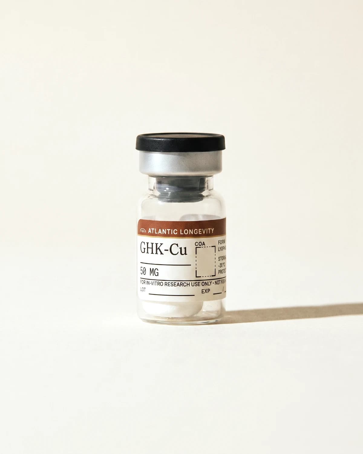 GHK-Cu vial with Atlantic Longevity batch label, lot and expiry write-in fields, on bone paper
