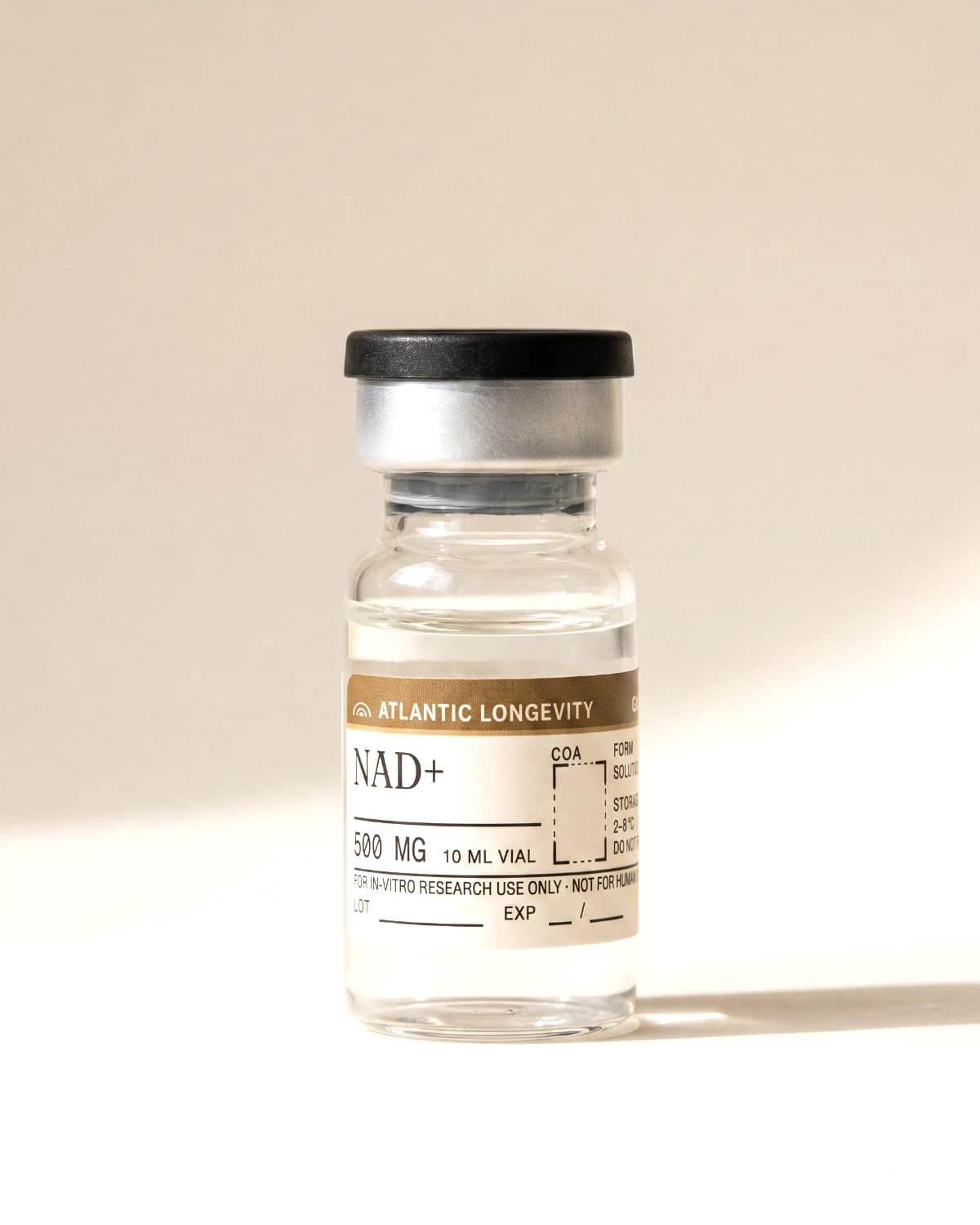 NAD+ vial with Atlantic Longevity batch label, lot and expiry write-in fields, on bone paper